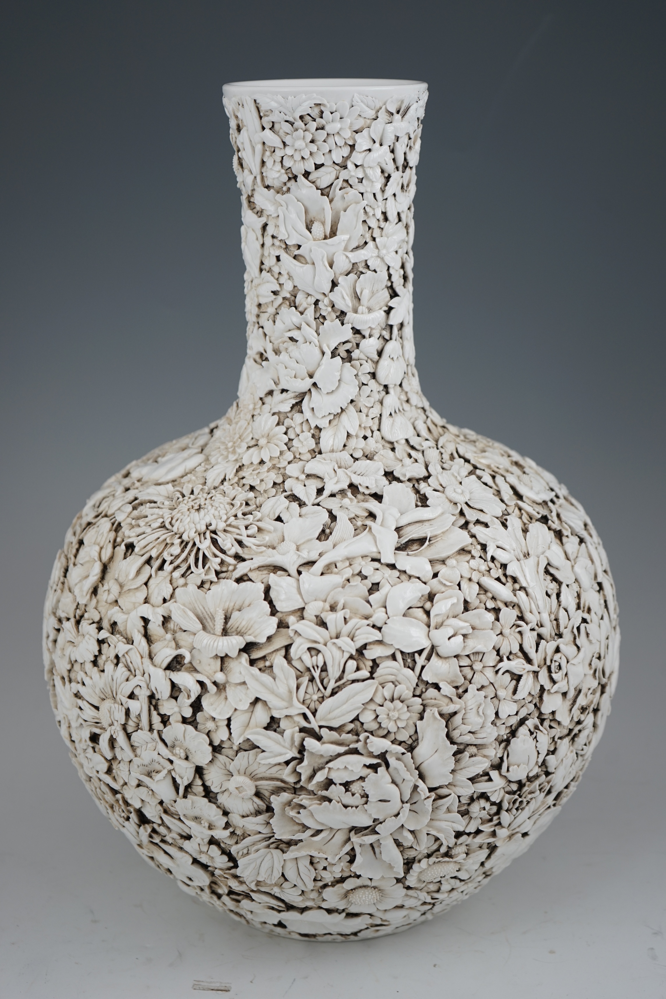 A large Chinese carved porcelain ‘thousand flower’ bottle vase, 20th century